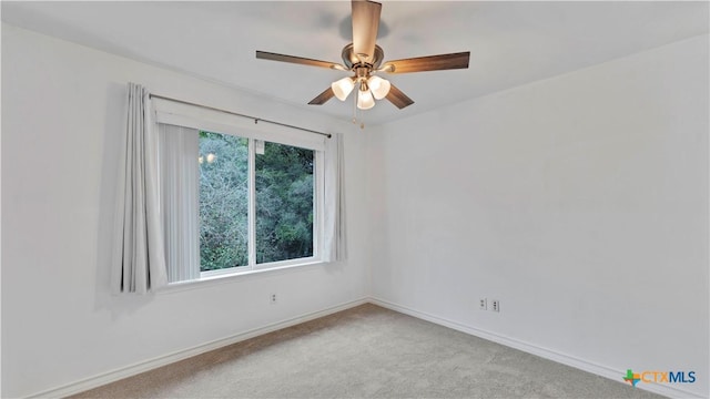 empty room featuring ceiling fan and light carpet