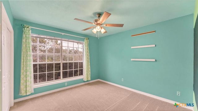 unfurnished room with carpet and ceiling fan