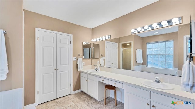 bathroom with vanity, tile patterned floors, and a shower with door