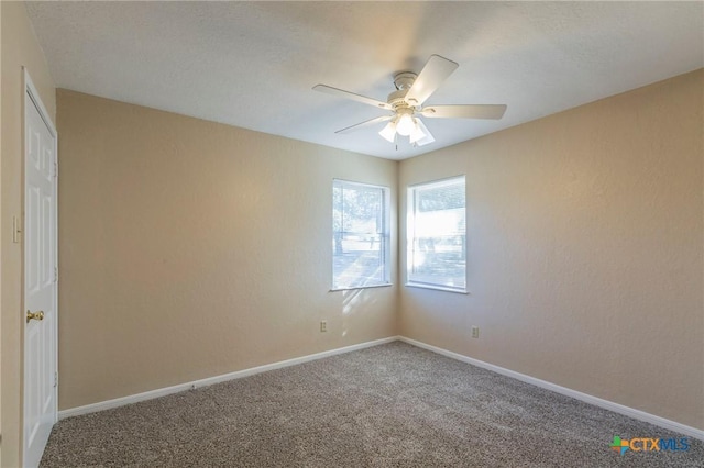 empty room with ceiling fan and carpet