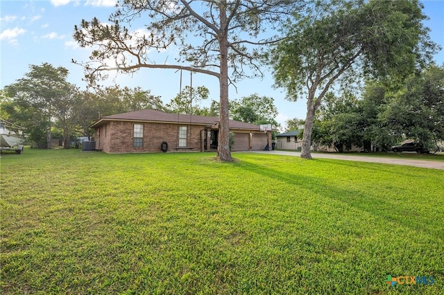 view of yard with driveway and a garage