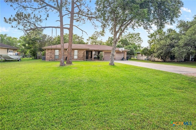 ranch-style house featuring a garage, driveway, and a front lawn