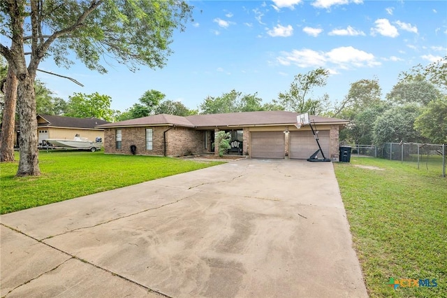 single story home featuring fence, an attached garage, brick siding, a front yard, and concrete driveway