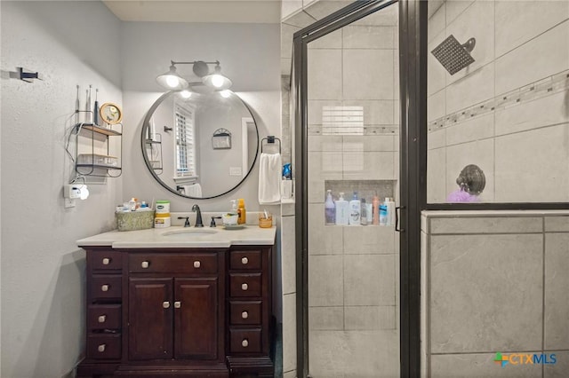 bathroom featuring vanity and a shower stall