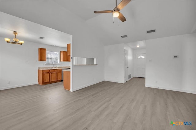 unfurnished living room with sink, ceiling fan with notable chandelier, light hardwood / wood-style flooring, and lofted ceiling