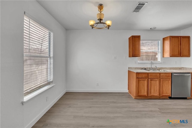 kitchen with sink, decorative light fixtures, light hardwood / wood-style flooring, and dishwasher