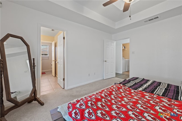 carpeted bedroom with washer and clothes dryer and ceiling fan