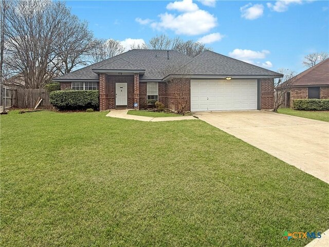 single story home featuring a garage and a front lawn