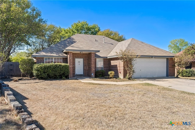 single story home featuring a garage and a front yard