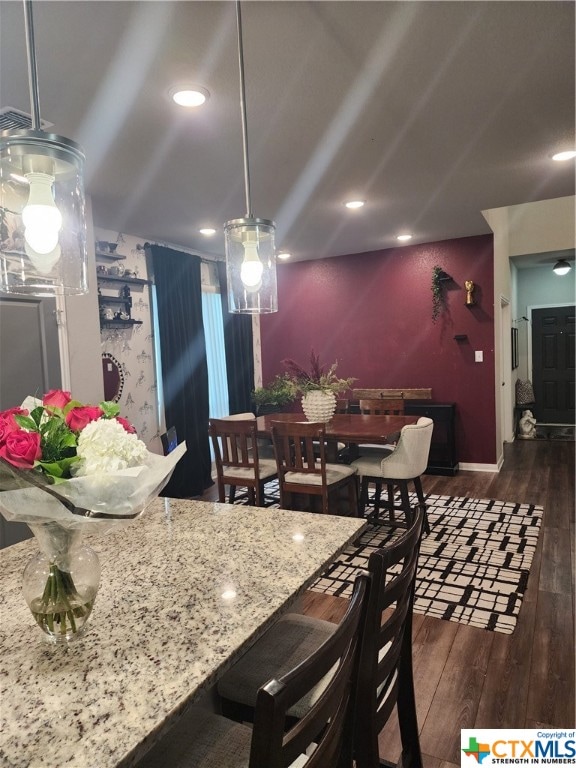 dining area with dark hardwood / wood-style flooring