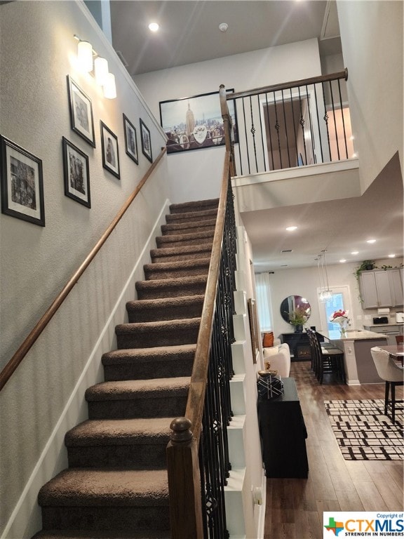 staircase with hardwood / wood-style flooring