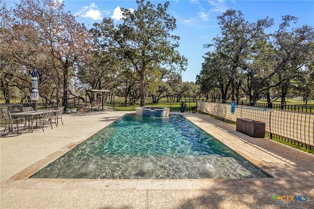 55 Post Oak Bnd, Inez, TX 77968 - view of swimming pool with a pool with connected hot tub, view of wooded area, and a patio