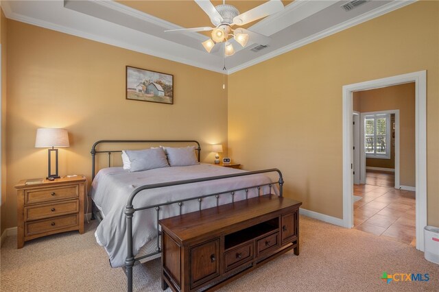 bedroom with ornamental molding, visible vents, and light colored carpet