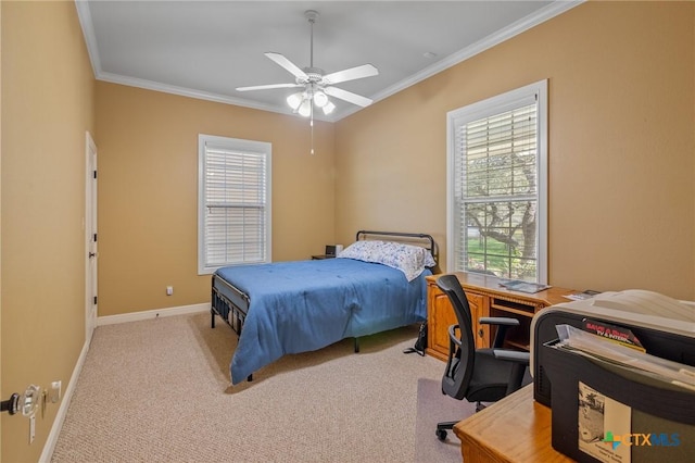 carpeted bedroom featuring baseboards, ornamental molding, and ceiling fan