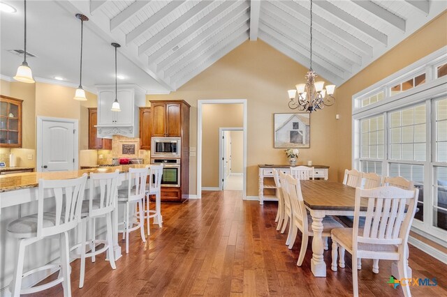 dining room with visible vents, baseboards, beam ceiling, dark wood-style floors, and an inviting chandelier