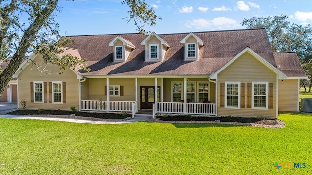 new england style home featuring covered porch, central AC unit, and a front yard