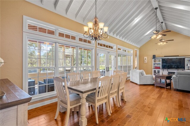 dining space with high vaulted ceiling, french doors, beamed ceiling, and light wood-style floors