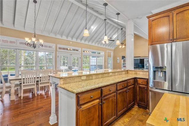 55 Post Oak Bnd, Inez, TX 77968 - kitchen featuring stainless steel refrigerator with ice dispenser, a peninsula, decorative light fixtures, and healthy amount of natural light