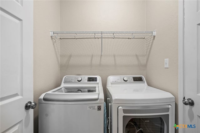 clothes washing area featuring laundry area and washer and dryer