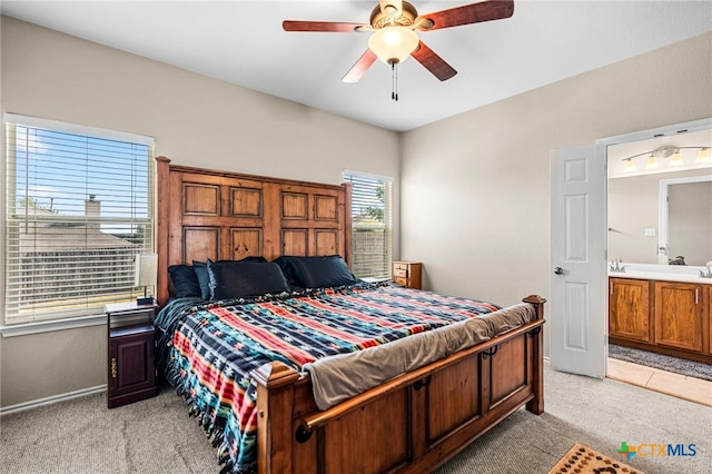 bedroom featuring light carpet, baseboards, and a ceiling fan