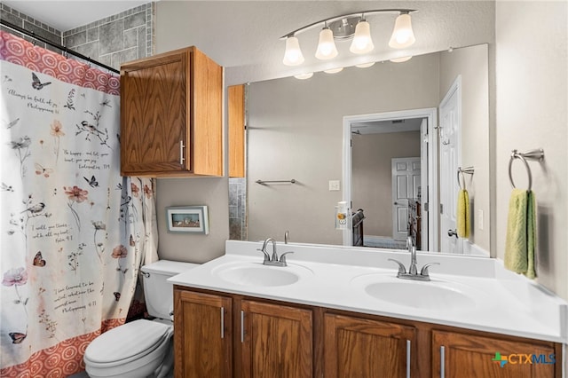 bathroom featuring toilet, double vanity, and a shower with curtain