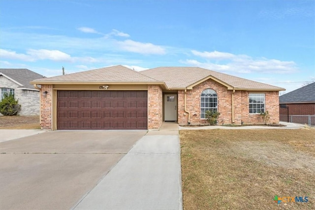 single story home featuring a garage and a front lawn