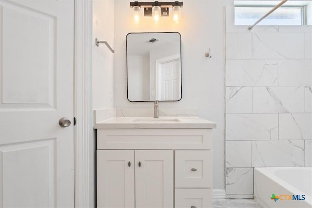 bathroom featuring vanity and tiled shower / bath combo