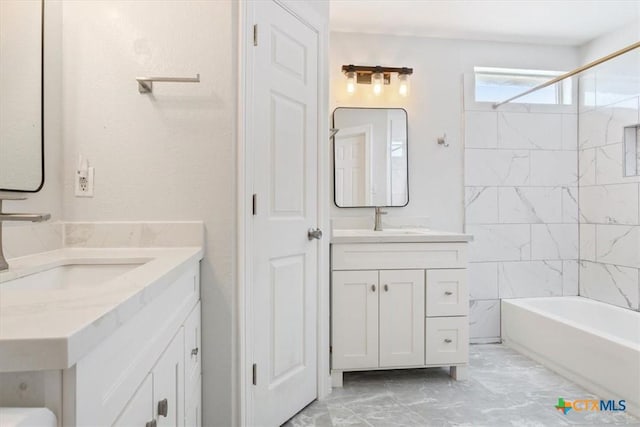 bathroom with vanity and tiled shower / bath