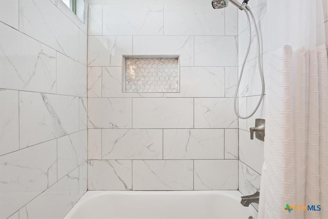 bathroom featuring shower / bathtub combination with curtain