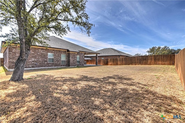 view of yard with a fenced backyard