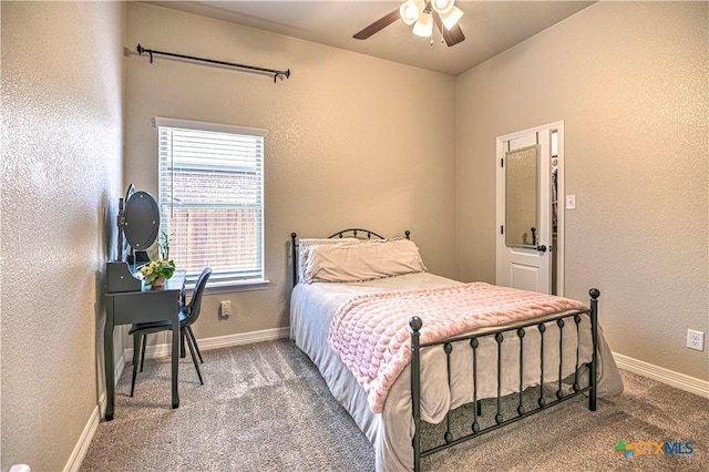 bedroom with carpet, baseboards, a textured wall, and ceiling fan