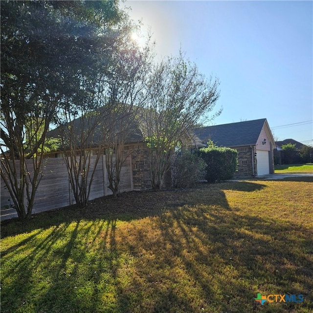 exterior space with a garage and a front lawn