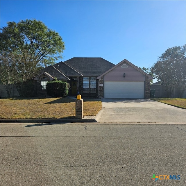 single story home with a garage and a front yard