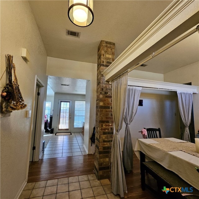 hallway with wood-type flooring and a textured ceiling