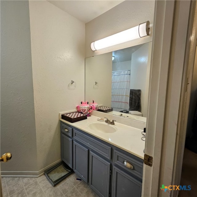 bathroom with tile patterned floors and vanity