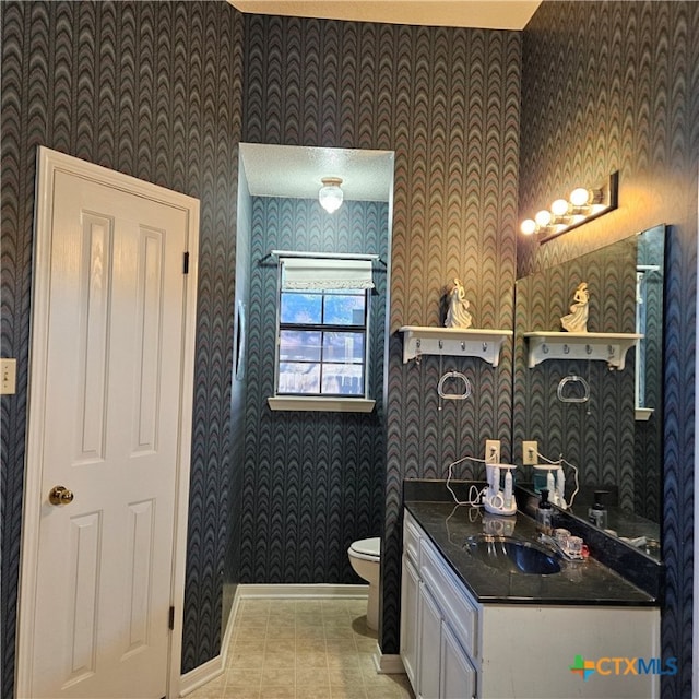 bathroom featuring tile patterned flooring, vanity, and toilet