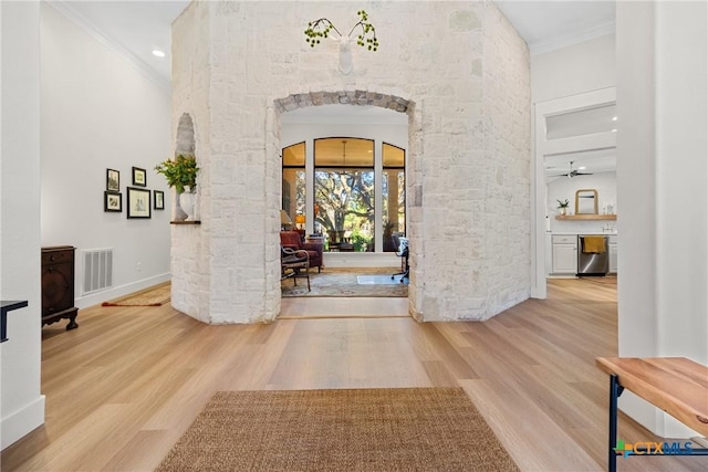 entryway featuring hardwood / wood-style flooring and ornamental molding