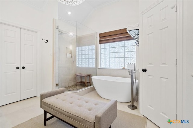 bathroom featuring ornamental molding, separate shower and tub, and lofted ceiling