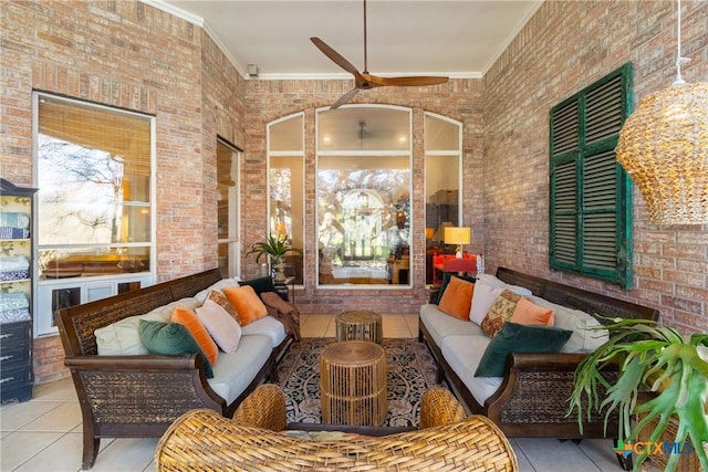 living room featuring light tile patterned floors, ornamental molding, a high ceiling, and brick wall