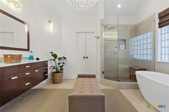 bathroom with tile patterned flooring, vanity, ornamental molding, and shower with separate bathtub