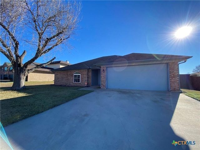 ranch-style home with a garage and a front yard