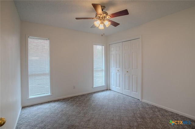 113 Ashford Dr, Victoria, TX 77904 - unfurnished bedroom with carpet, baseboards, a closet, and ceiling fan