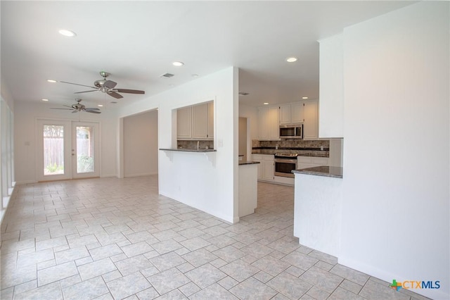 113 Ashford Dr, Victoria, TX 77904 - unfurnished living room featuring a ceiling fan, recessed lighting, and french doors