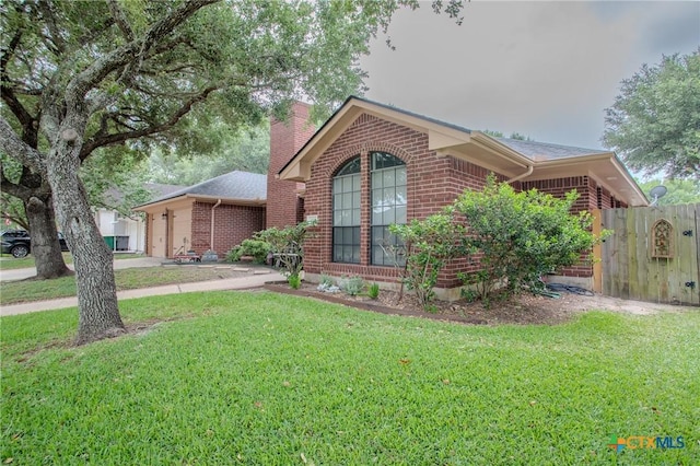 113 Ashford Dr, Victoria, TX 77904 - ranch-style house featuring brick siding, a chimney, and roof with shingles