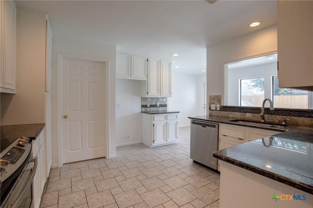 113 Ashford Dr, Victoria, TX 77904 - kitchen with dishwasher, a sink, decorative backsplash, white cabinets, and dark stone countertops