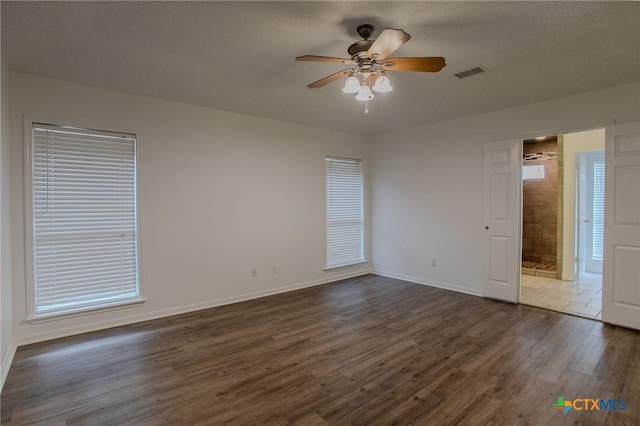 113 Ashford Dr, Victoria, TX 77904 - unfurnished room featuring dark wood finished floors, ceiling fan, and baseboards