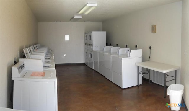 community laundry room with washer and clothes dryer and stacked washer / dryer