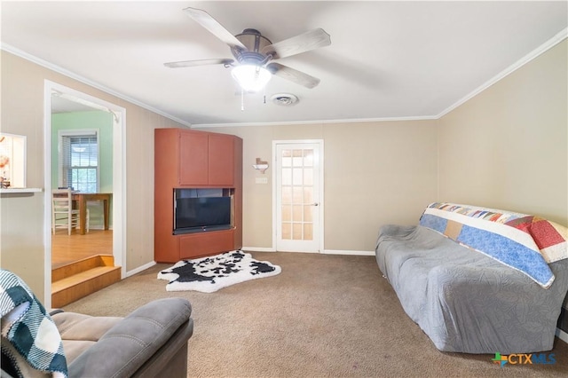 516 2nd St, Cuero, TX 77954 - living area with healthy amount of natural light, crown molding, ceiling fan, and carpet
