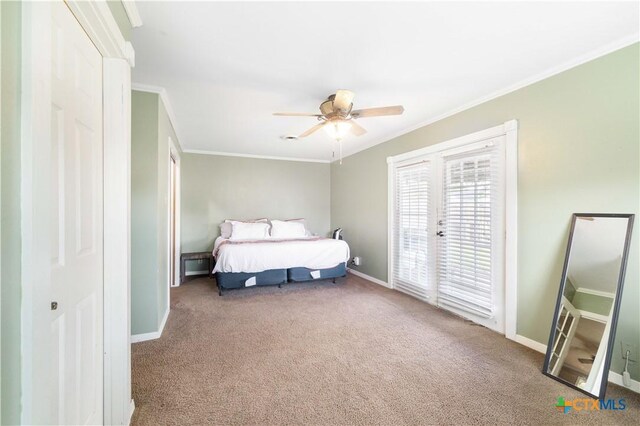 516 2nd St, Cuero, TX 77954 - carpeted bedroom with ornamental molding, access to exterior, and ceiling fan