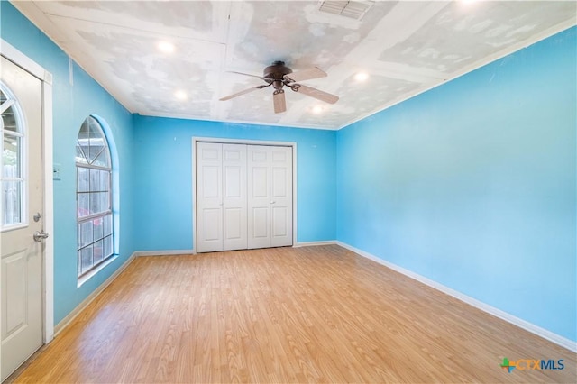 516 2nd St, Cuero, TX 77954 - unfurnished bedroom with wood finished floors, a closet, recessed lighting, and a ceiling fan